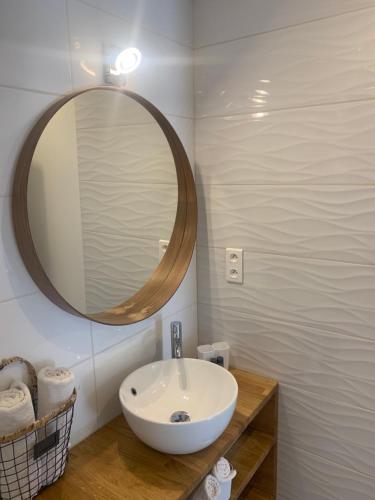 a bathroom with a white sink and a mirror at Hôtel Beau Soleil in Le Lavandou
