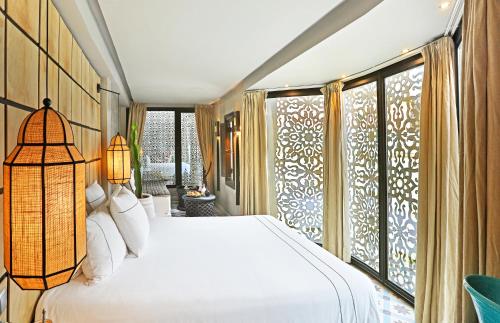 a bedroom with a bed and a large window at Dar Kandi in Marrakech