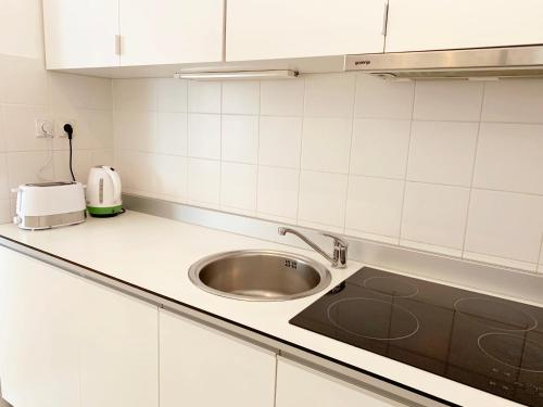 a kitchen with a sink and a counter top at Miu Arena Apartment in Belgrade