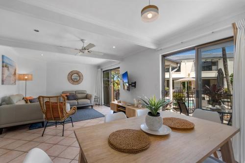 a living room with a table and a couch at Noosa Place Resort in Noosaville