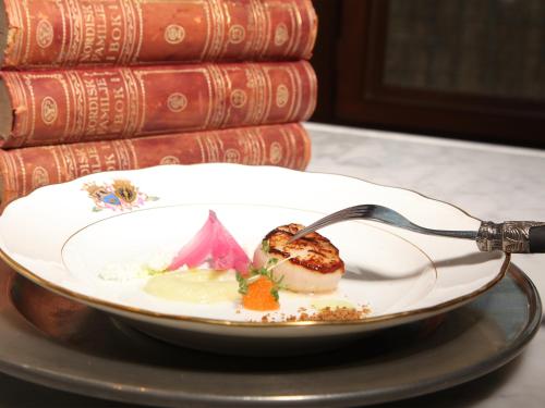 a plate of food on a table with a fork at Södertuna Slott in Gnesta