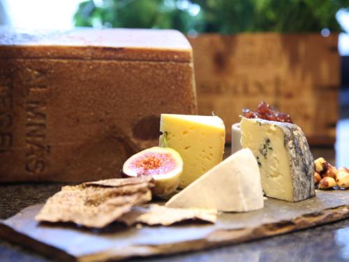 a plate of cheese and crackers on a table at Södertuna Slott in Gnesta