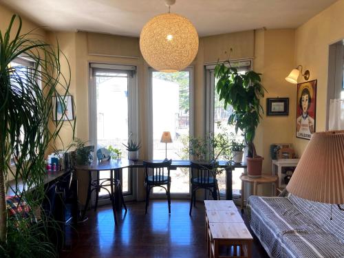 a living room with a table and chairs and a couch at Bellscabin Guesthouse in Karuizawa