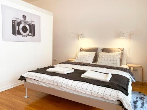 a bedroom with a bed with a speaker on the wall at Miu Arena Apartment in Belgrade