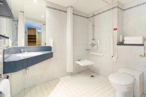 a bathroom with a toilet and a sink and a shower at Holiday Inn Express Park Royal, an IHG Hotel in London
