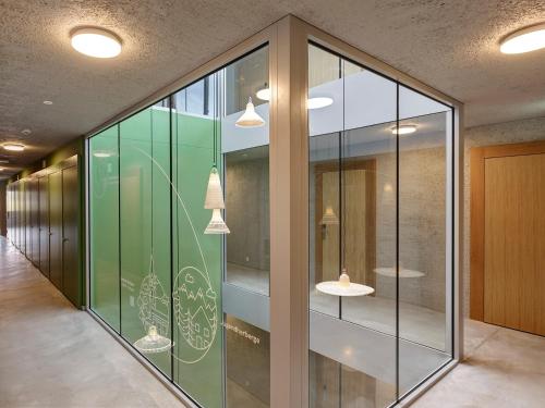 a hallway of a building with glass walls at Schaan-Vaduz Youth Hostel in Schaan