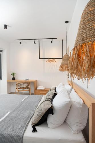 a bedroom with a bed with a pile of pillows at Villa Calma in Kamilari