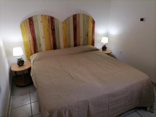 a bedroom with a large bed with two tables at Alloggi Estivi D & A in Taranto