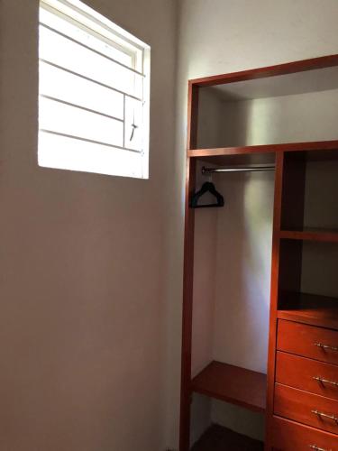 a bedroom with a window and a dresser at Maria Del Alma House in Mexico City