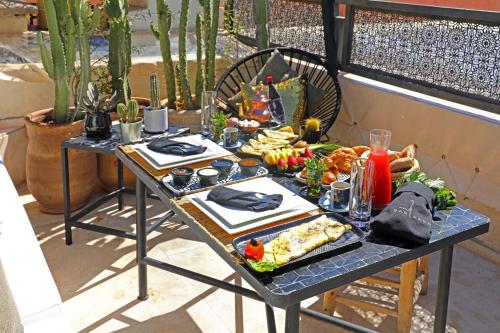 a table with food on it on a patio at Dar Kandi in Marrakech