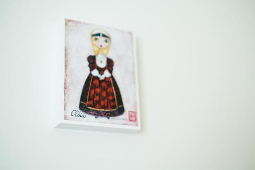 a picture of a woman in a dress on a wall at Enjoy Your Stay - Guest House - Olbia in Olbia