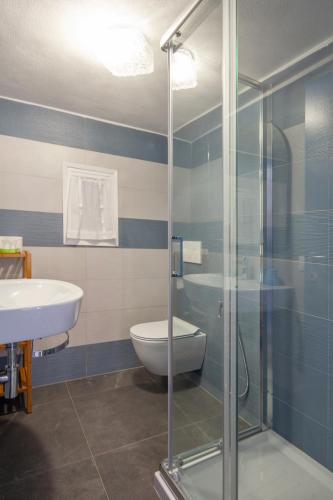a bathroom with a shower and a toilet and a sink at Ludovica Flat in Vernazza