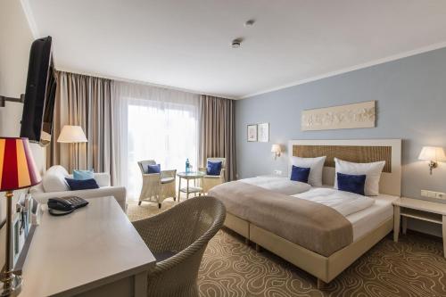 Ένα ή περισσότερα κρεβάτια σε δωμάτιο στο Mein Strandhaus - Hotel, Restaurant & Schwimmbad