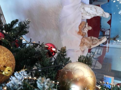 a christmas tree with christmas decorations in a room at Hotel La Posta del Dayman in Termas del Daymán