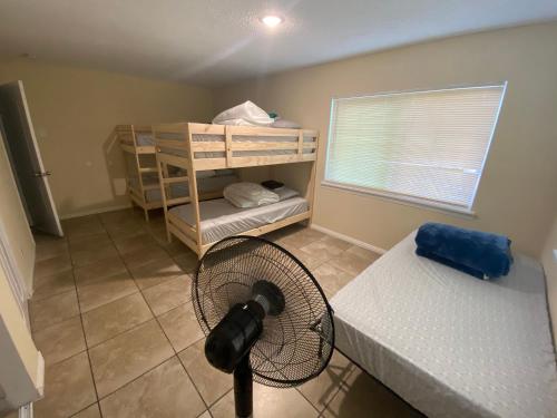a room with two bunk beds and a fan at Casa Tranquila in Santa Ana