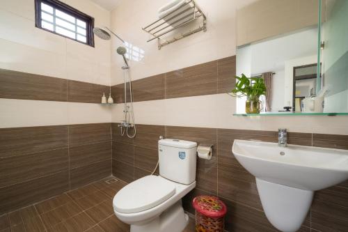 a bathroom with a toilet and a sink at Spring Garden Villa Hoi An in Hoi An