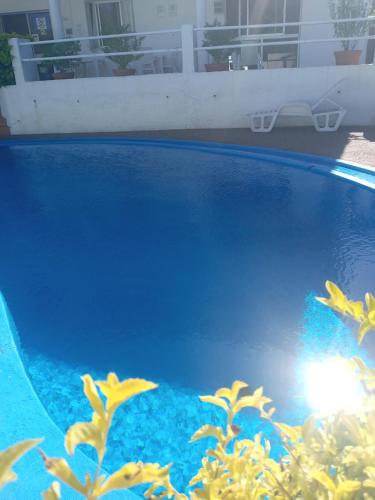 a close up of a blue swimming pool at Hotel La Posta del Dayman in Termas del Daymán