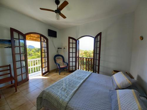 a bedroom with a bed and a balcony at Homestay Villa Giulia in Juquei