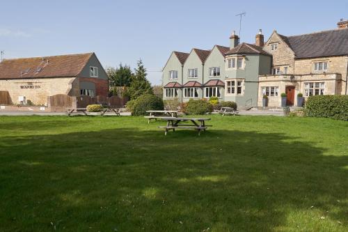 a park with a picnic table in the middle of a field at Beckford Inn in Beckford