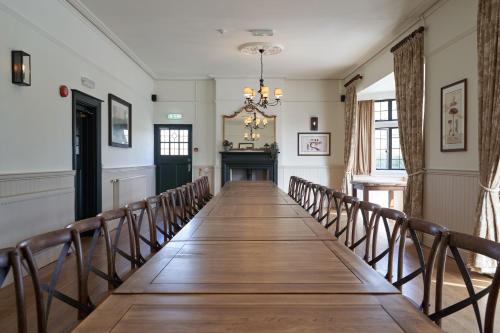 a long boardwalk in a room with chairs at Beckford Inn in Beckford