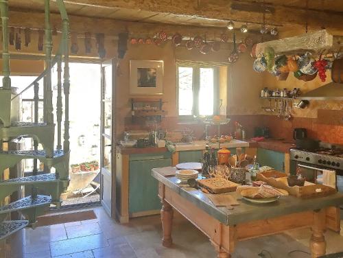 a kitchen with a table in the middle of it at La Grange de la Lavande in Lardiers