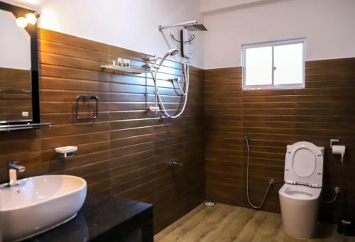 a bathroom with a sink and a toilet and a window at 4 Aces Ella in Ella