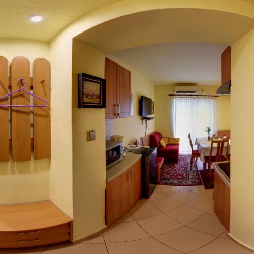 a kitchen and living room with a dining room at Penzion U Lesa in České Budějovice
