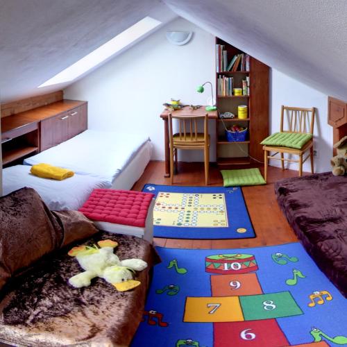 a bedroom with a bed and a table and a desk at Penzion U Lesa in České Budějovice