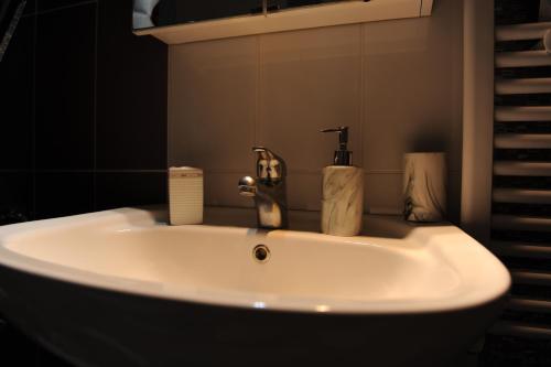 a bathroom sink with a faucet on top of it at Rafaela's Apartment in Samos