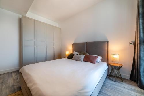 a bedroom with a large white bed with two pillows at Onix 75 in Mamaia Sat/Năvodari