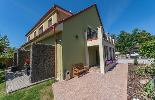 a house with a brick patio in front of it at Třeboňské Apartmány in Třeboň