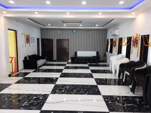 a room with a black and white checkered floor at SM Guest House in Lucknow