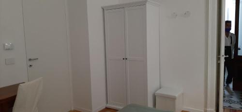 a room with white walls and a white closet at MY BED affittacamere in Cuneo