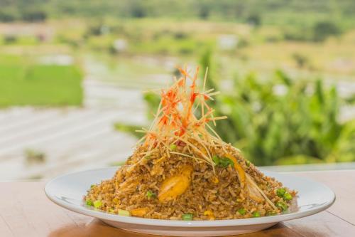 a plate with a pile of food on a table at Urqu Hotel & Boutique in Jaén