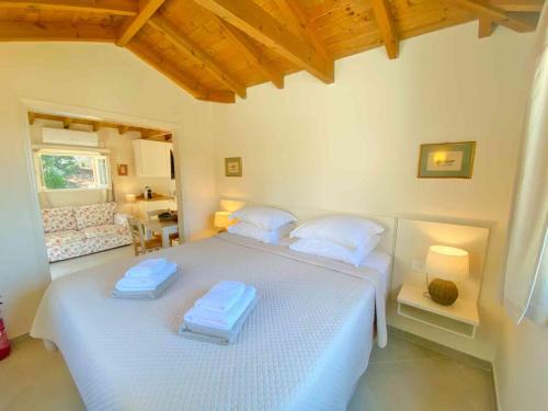 a bedroom with two beds with towels on them at Paleopetres K-Six - Premium Suite - Kalami - in Kalami