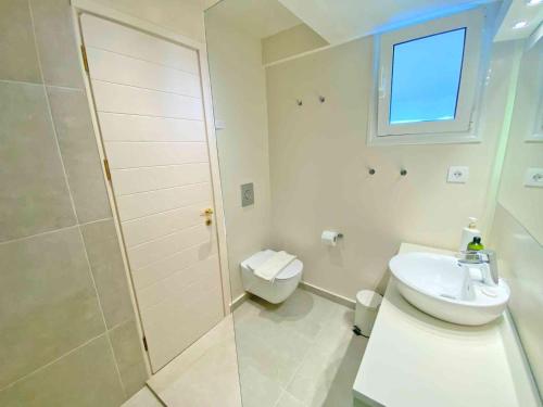 a white bathroom with a shower and a sink at Paleopetres K-Six - Premium Suite - Kalami - in Kalami