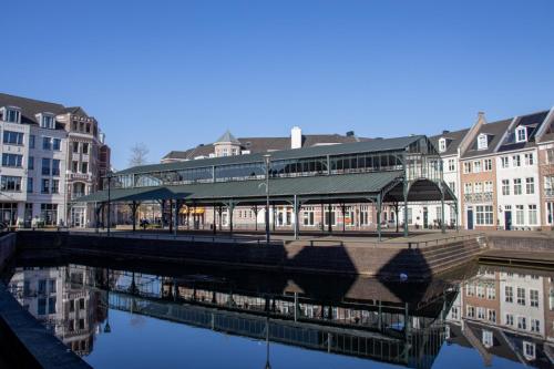 a building with a bridge over a river with buildings at Jacky's place in Helmond