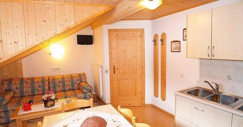 a living room with a couch and a sink at Pinterhof in San Vigilio Di Marebbe