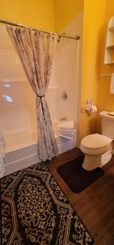 a bathroom with a toilet and a shower at Vacation Homes by The Bulldog- Berker's Suite A in Silver Star