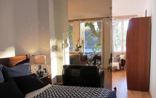 a bedroom with a bed and a sliding glass door at Porto Douro River Guest House in Porto