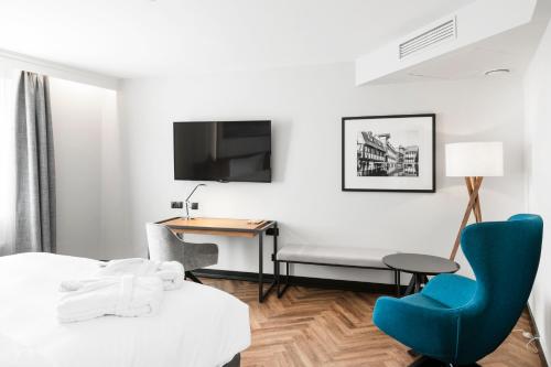 a hotel room with a bed and a desk at MERCURE KLAIPEDA CITY HOTEL, Meetings, Events, Restaurant & Bar - Accor Group, Pet Stay FREE in Klaipėda