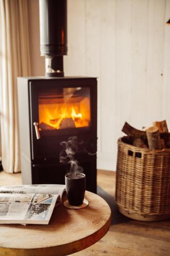 a cup of coffee on a table in front of a fireplace at Glasson Lakehouse in Athlone