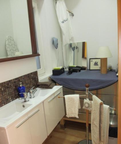 a bathroom with a sink and a blue table at Porto Douro River Guest House in Porto