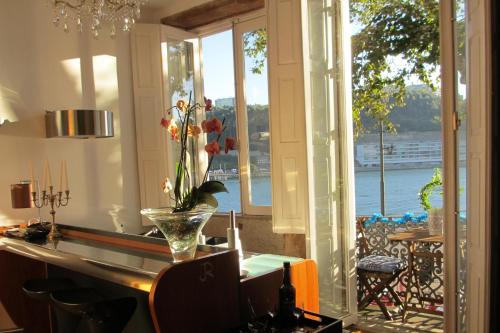 a kitchen with a window with a view of the water at Porto Douro River Guest House in Porto