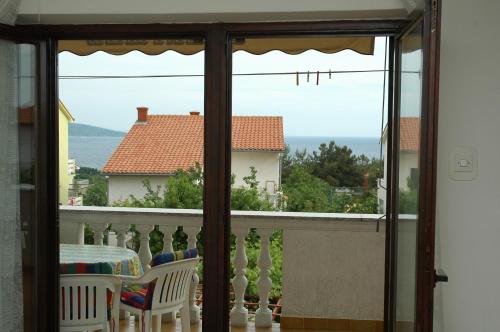 a view of a balcony with a table and chairs at Apartments Jurina 2 in Krk