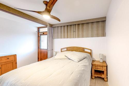 a bedroom with a bed and a ceiling fan at Hale Kai O Kihei in Kihei