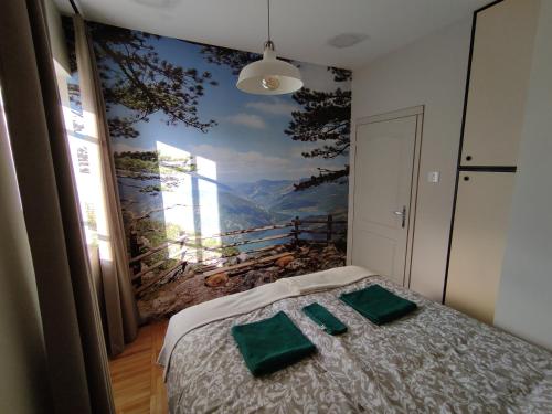 a bedroom with a painting on the wall at Srafko apartment in Subotica