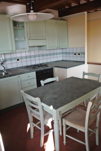 a kitchen with a table with chairs and a stove at Casa Torre in Arezzo