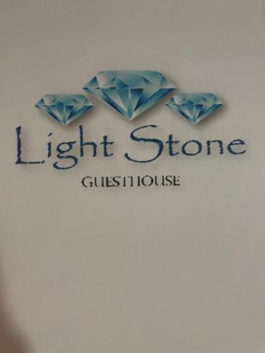 a sign for a light store with two blue diamonds at LightStone Guesthouse in Centurion