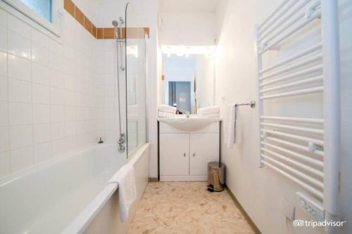 une salle de bain blanche avec un lavabo et une douche dans l'établissement Le Maurifleur vous accueille à 3 km de Honfleur, à Équemauville